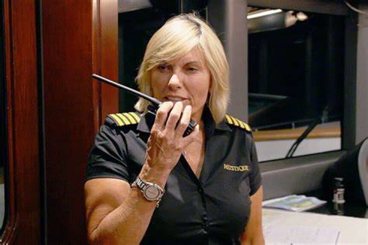 Captain Sandy is speaking to the mic as she expresses her words through her hands.