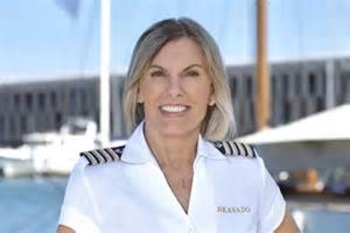 Captain Sandy is wearing a red shirt in the picture as she is talking to the camera. 