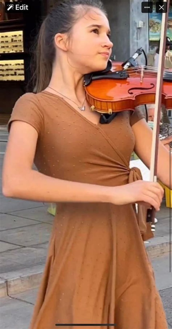 Karolina Protsenko posing with her family members by wearing beautiful dress.