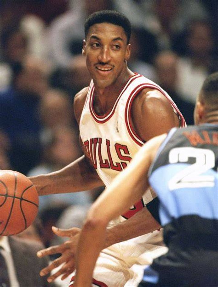 Scottie Pippen is posing for the photo.