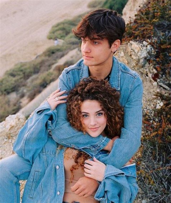 Sofie Dossi and her boyfriend Dom Brack kissing in front of the Disneyland Palace during an evening date.